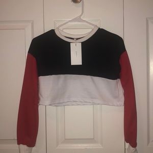 Cropped long sleeve. Never worn.